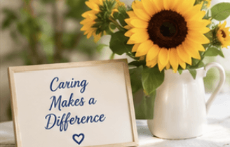 Sunflowers and a sign that reads Caring Makes a Difference